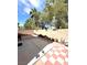 The backyard boasts mature trees providing cooling shade, with brick wall and tiled patio at 8156 Blue Hope Diamond Ln, Las Vegas, NV 89139