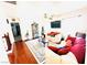 Open-concept living room with cozy couches, wood floors, and lots of natural light at 8156 Blue Hope Diamond Ln, Las Vegas, NV 89139