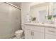 Bathroom featuring a shower with glass doors, a white vanity with a granite countertop, and modern fixtures at 8600 W Charleston Blvd # 2187, Las Vegas, NV 89117