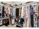 Organized walk-in closet filled with clothing, shoes, and accessories on shelves and hanging rods at 8600 W Charleston Blvd # 2187, Las Vegas, NV 89117