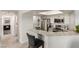 Open-concept kitchen with bar seating, modern appliances, and seamless flow to the living area at 8600 W Charleston Blvd # 2187, Las Vegas, NV 89117