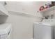 Functional laundry room featuring a washer, a dryer, and built-in shelving at 8600 W Charleston Blvd # 2187, Las Vegas, NV 89117
