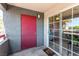 Exterior patio entrance with a red front door, a sliding glass door, and a doormat at 8600 W Charleston Blvd # 2187, Las Vegas, NV 89117