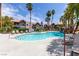 Sparkling pool surrounded by palm trees and lounge chairs, perfect for relaxing and enjoying the sunny weather at 8600 W Charleston Blvd # 2187, Las Vegas, NV 89117