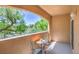 Cozy balcony with wrought iron table and chairs overlooks lush greenery, offering a relaxing outdoor space at 8737 Red Brook Dr # 204, Las Vegas, NV 89128