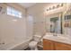 Well-lit bathroom with shower-tub combo and vanity with modern fixtures at 8737 Red Brook Dr # 204, Las Vegas, NV 89128