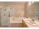 A neutral toned bathroom features a walk-in shower, tub, and sink with vanity at 8737 Red Brook Dr # 204, Las Vegas, NV 89128