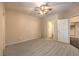 Spacious bedroom featuring neutral walls, ceiling fan and carpeting at 8737 Red Brook Dr # 204, Las Vegas, NV 89128