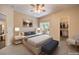 Staged main bedroom featuring a platform bed and access to the closet and patio at 8737 Red Brook Dr # 204, Las Vegas, NV 89128