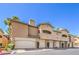 Exterior view of townhome with garages, showcases architecture, and nearby landscaping, highlighting curb appeal at 8737 Red Brook Dr # 204, Las Vegas, NV 89128