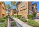 Exterior of condo showing sidewalk and desert landscaping between units in a multi-unit building at 8737 Red Brook Dr # 204, Las Vegas, NV 89128