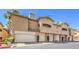 Multi-unit condo complex showing attached garages and stucco exteriors with desert landscaping at 8737 Red Brook Dr # 204, Las Vegas, NV 89128