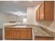 A bright kitchenette featuring granite countertops and light wood cabinets at 8737 Red Brook Dr # 204, Las Vegas, NV 89128