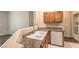 A bright kitchenette with light wood cabinets, granite countertops, and white appliances at 8737 Red Brook Dr # 204, Las Vegas, NV 89128