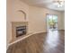 Living room featuring a granite fireplace and a sliding glass door to the outside patio at 8737 Red Brook Dr # 204, Las Vegas, NV 89128