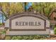 Stone entrance sign that reads 'REDHILLS' offers a warm welcome to this well-maintained community at 8737 Red Brook Dr # 204, Las Vegas, NV 89128