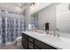 Modern bathroom with double sinks, quartz counters, a shower with curtain, and neutral finishes at 8941 Indigo Rose St, Las Vegas, NV 89166