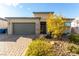 Charming single-story home featuring a two-car garage, neutral colors, and desert landscaping at 8941 Indigo Rose St, Las Vegas, NV 89166