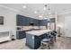 Beautiful kitchen with blue cabinets, stainless steel appliances, and a large island with seating at 8941 Indigo Rose St, Las Vegas, NV 89166