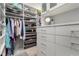 Spacious walk-in closet featuring custom shelving, drawers, and hanging rods for optimal organization at 8941 Indigo Rose St, Las Vegas, NV 89166