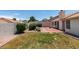 Backyard with grass and desert landscaping and small patio area at 904 Big Horn St, Henderson, NV 89002