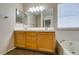 Bathroom vanity with double sinks, a large mirror, and wood cabinets at 904 Big Horn St, Henderson, NV 89002