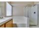 Bathroom features shower, tub, and tile surround at 904 Big Horn St, Henderson, NV 89002