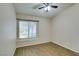 This bedroom features wood floors, a ceiling fan, and a window with blinds at 904 Big Horn St, Henderson, NV 89002