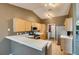 Spacious kitchen with light-colored cabinets, stainless appliances, and breakfast bar at 904 Big Horn St, Henderson, NV 89002