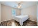 Cozy bedroom with a ceiling fan, plantation shutters and beautiful hardwood floors at 9050 W Tropicana Ave # 1015, Las Vegas, NV 89147