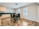 A modern dining area with wood-look flooring and a black countertop at 9050 W Tropicana Ave # 1015, Las Vegas, NV 89147