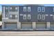 Contemporary townhome exterior featuring three garage doors and neutral color scheme at 9050 W Tropicana Ave # 1015, Las Vegas, NV 89147