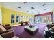 Bright community lounge featuring comfortable seating, purple carpet, and views of the pool area at 9050 W Tropicana Ave # 1015, Las Vegas, NV 89147