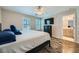 A bright main bedroom featuring wood-look floors, a ceiling fan, and a large bed at 9050 W Tropicana Ave # 1015, Las Vegas, NV 89147