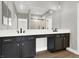 A modern bathroom with double sinks, dark cabinets, and a large mirror at 9116 Vista Greens Way # 104, Las Vegas, NV 89134