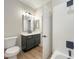 Bathroom features white subway tile surround, black fixtures, new vanity, and granite countertop at 9116 Vista Greens Way # 104, Las Vegas, NV 89134
