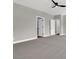 A large bedroom featuring a ceiling fan, neutral paint and carpet, and two white doors at 9116 Vista Greens Way # 104, Las Vegas, NV 89134