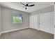 Bedroom with carpeted floors, large window, and closet with sliding doors at 9116 Vista Greens Way # 104, Las Vegas, NV 89134