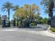 Community entrance with landscaped signage and gated access at 9116 Vista Greens Way # 104, Las Vegas, NV 89134