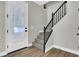 Foyer with black staircase and a glass detailed front door, with modern lighting at 9116 Vista Greens Way # 104, Las Vegas, NV 89134