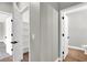 Hallway with white trim, gray walls, and views into other rooms at 9116 Vista Greens Way # 104, Las Vegas, NV 89134