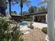 Community hot tub features lounge chairs, lush greenery, covered patio, set under clear skies with mature landscaping at 9116 Vista Greens Way # 104, Las Vegas, NV 89134
