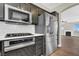 Kitchen features stainless steel appliances, stone countertops, recessed lighting, and hardwood floors at 9116 Vista Greens Way # 104, Las Vegas, NV 89134