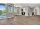 Open concept living area with wood floors, natural light, and an outdoor balcony at 9116 Vista Greens Way # 104, Las Vegas, NV 89134