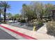 Community parking area next to the pool with mature trees, manicured landscaping, easy access to amenities at 9116 Vista Greens Way # 104, Las Vegas, NV 89134