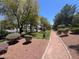 Path through the community with mature trees and landscaping at 9116 Vista Greens Way # 104, Las Vegas, NV 89134