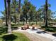 Community picnic area with table and benches, surrounded by mature trees and clear skies at 9116 Vista Greens Way # 104, Las Vegas, NV 89134