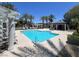 Relaxing community pool with many lounge chairs, an umbrella seating area and palm trees at 9116 Vista Greens Way # 104, Las Vegas, NV 89134