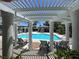 Community pool with covered seating area, lounge chairs, and well maintained landscaping at 9116 Vista Greens Way # 104, Las Vegas, NV 89134