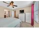 This carpeted bedroom has bright natural light, and a ceiling fan at 9118 Mount Wilson St, Las Vegas, NV 89113